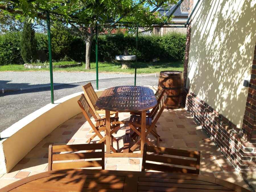 Shaded terrace and garden at Hôtel de la Risle